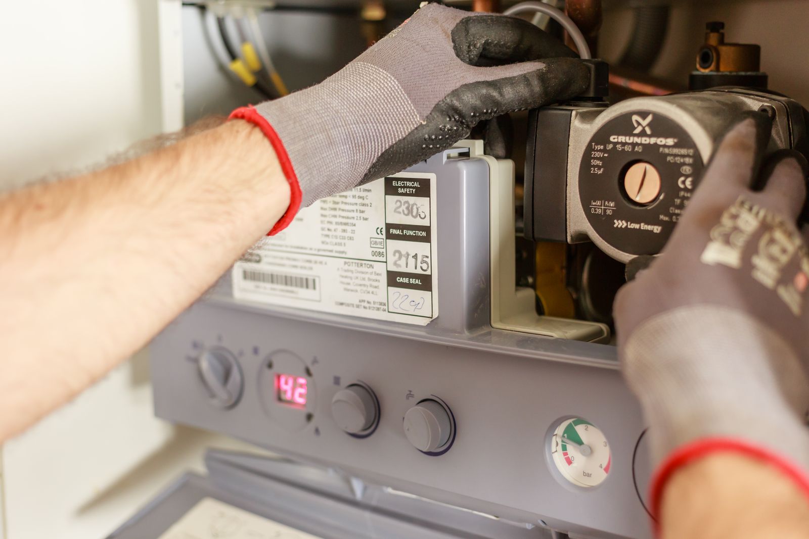 Technician servicing the internal components of a home heating system